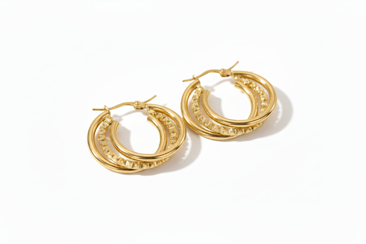 Gold hoop earrings on a white background