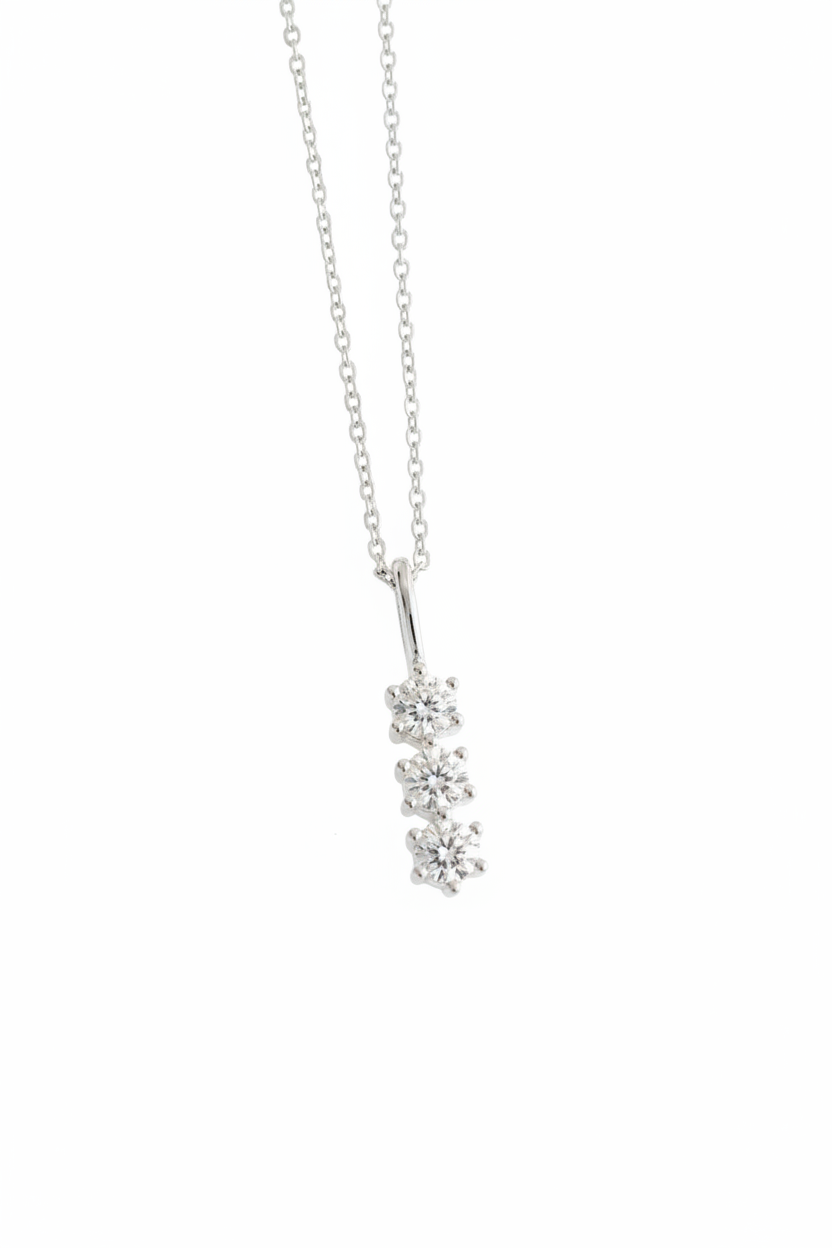 Silver necklace with a floral pendant on a light gray background