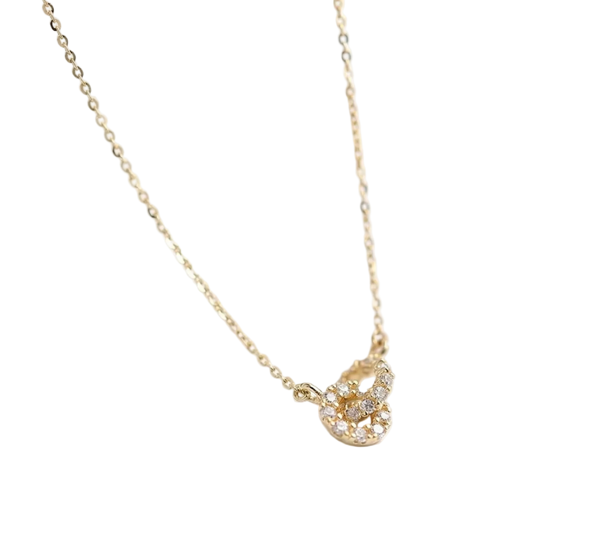 Gold necklace with a delicate pendant on a white background