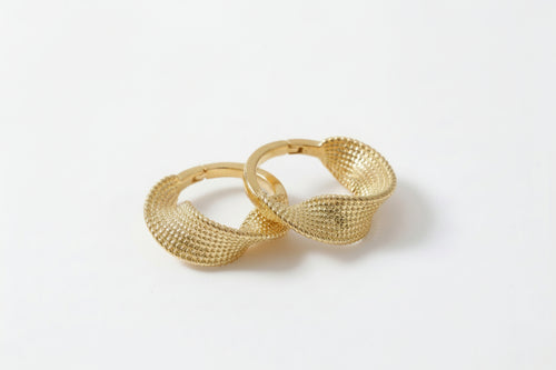 Gold hoop earrings on a white background